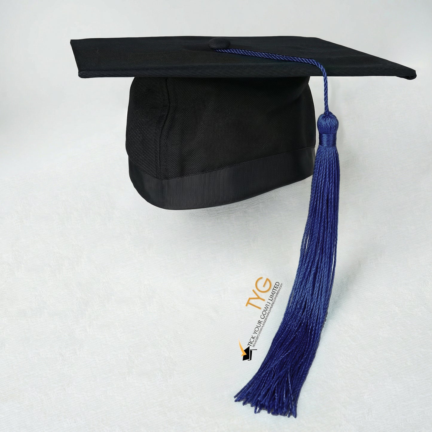 Black graduation cap with dark blue tassel on a white background