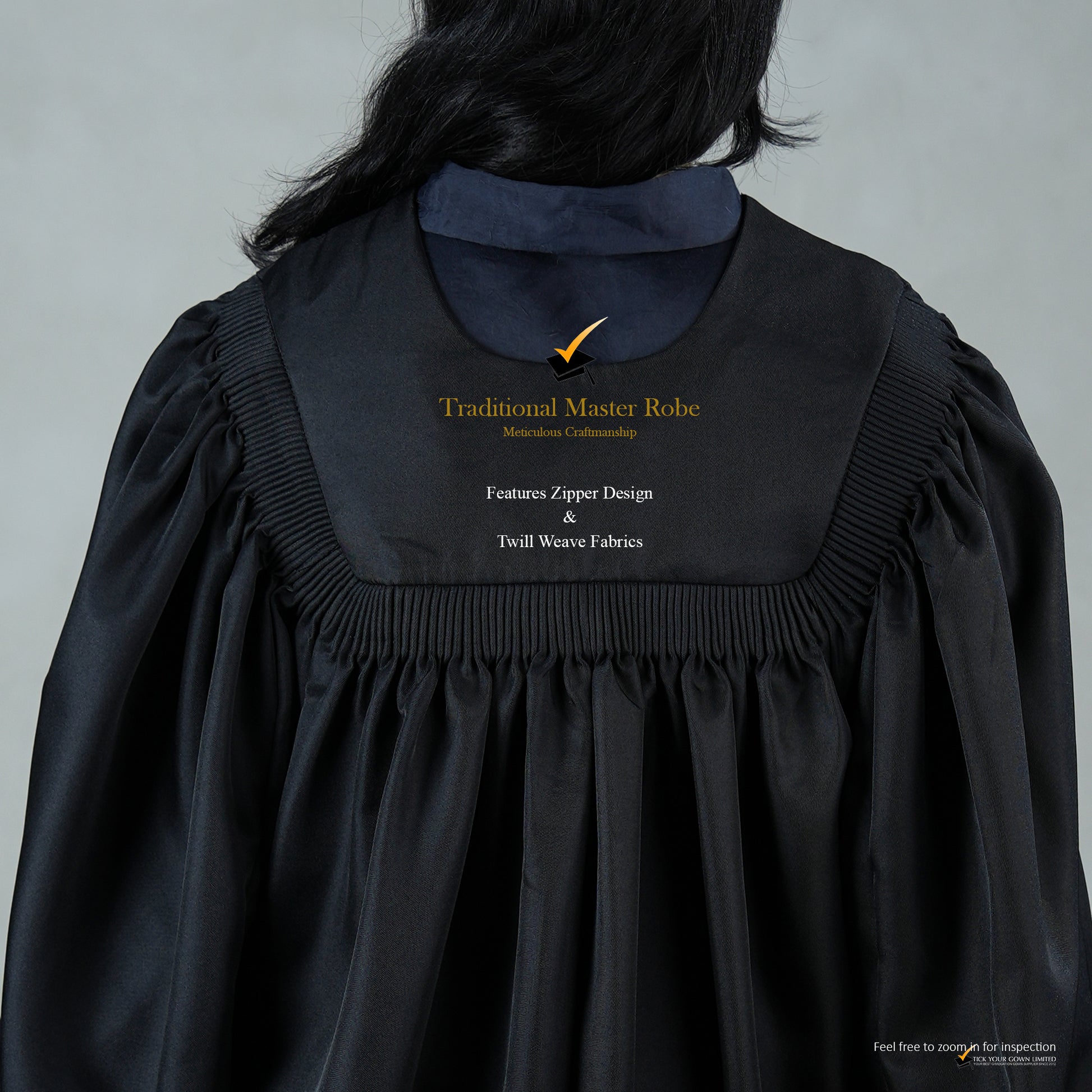 An upper back detailed view of a person wearing a traditional black master's robe for the blue hood set