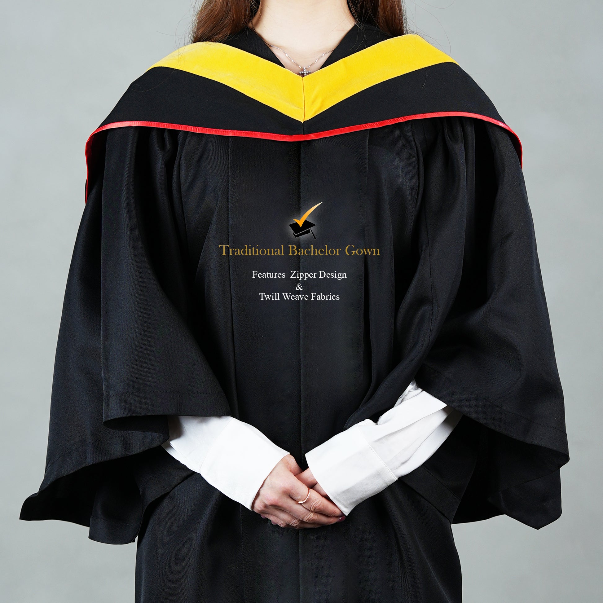 Front close-up of a black bachelor graduation gown showing the yellow and red-trim satin hood drape over the shoulders.