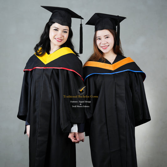 Two individuals wearing black bachelor gowns with mortarboards, one with a yellow hood and the other with a blue hood, standing against a gray background.