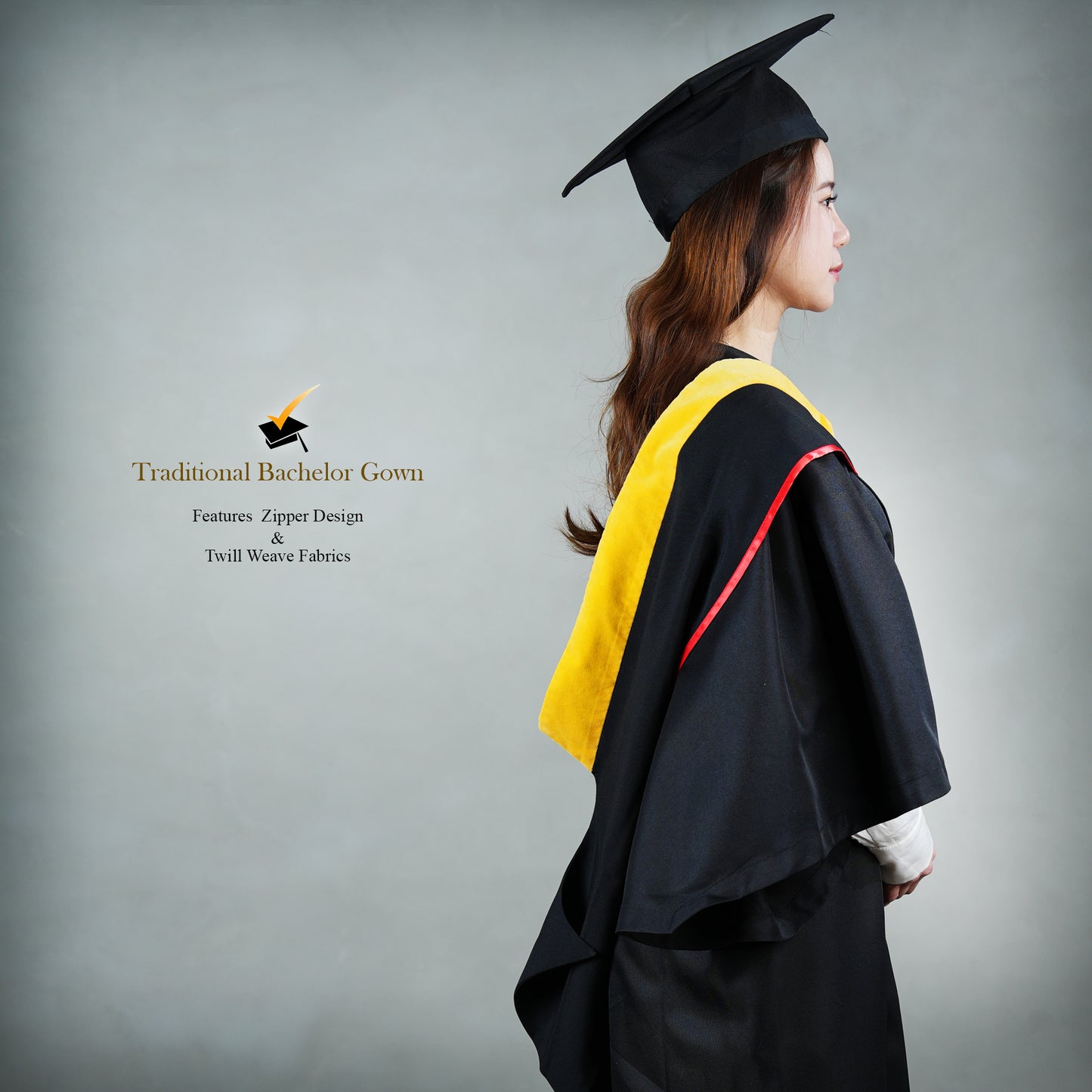 Side view of a person wearing a classic set of a black bachelor graduation gown with a yellow satin hood, red trim detail, and a mortarboard cap.