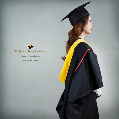 Side view of a person wearing a classic set of a black bachelor graduation gown with a yellow satin hood, red trim detail, and a mortarboard cap.