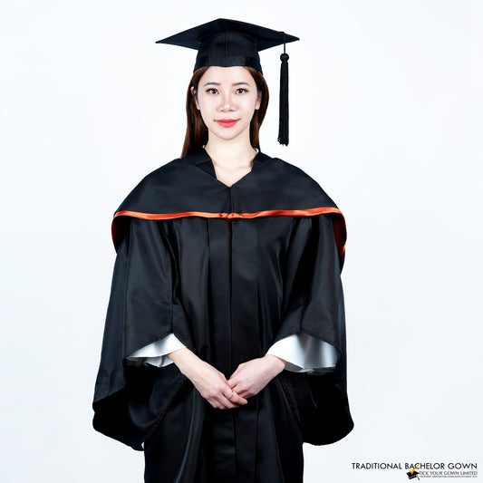 A person wearing a black bachelor graduation gown with a satin hood highlighted on the edge, and a mortarboard