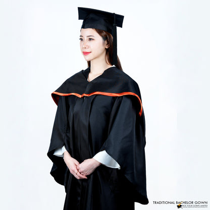 A person wearing a black bachelor graduation gown viewed from a front-side angle with a highlighted satin hood, and a mortarboard