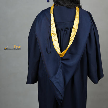 A detailed back view of a graduate in a navy gown with a yellow hood against a gray background