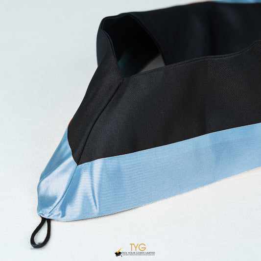 Detailed view of a bachelor’s graduation hood in black with light blue satin lining.
