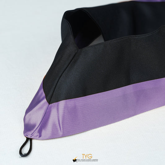 Detailed view of a bachelor’s graduation hood in black with purple satin lining.