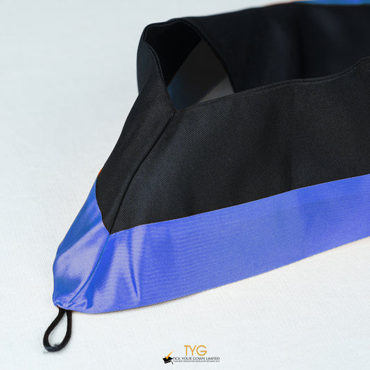 Detailed view of a bachelor’s graduation hood in black with navy satin lining.
