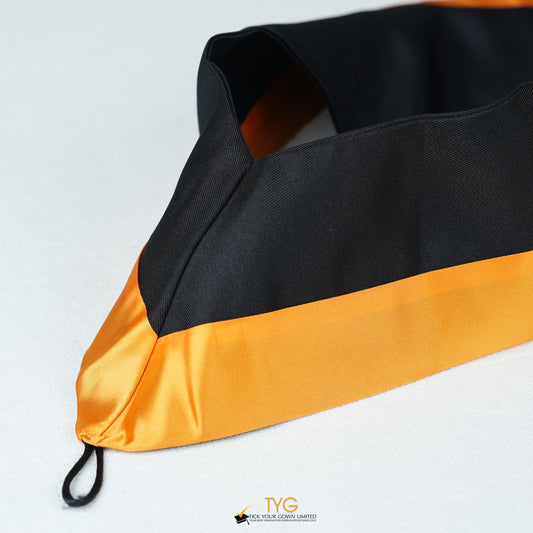 Detailed view of a bachelor’s graduation hood in black with orange satin lining.