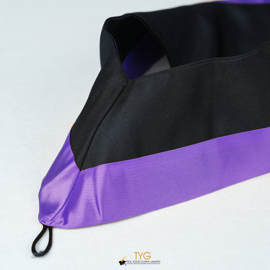 Detailed view of a bachelor’s graduation hood in black with purple satin lining.