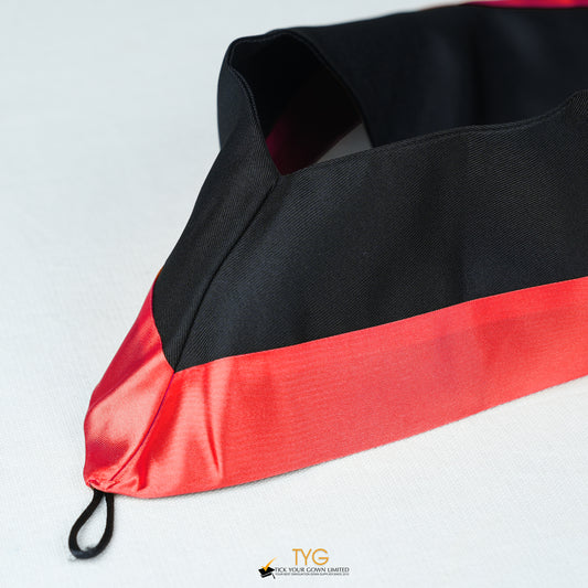 Detailed view of a bachelor’s graduation hood in black with red satin lining.