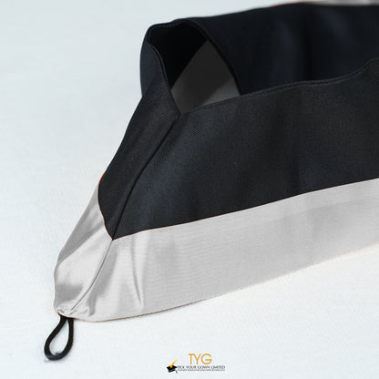 Detailed view of a bachelor’s graduation hood in black with silver satin lining.