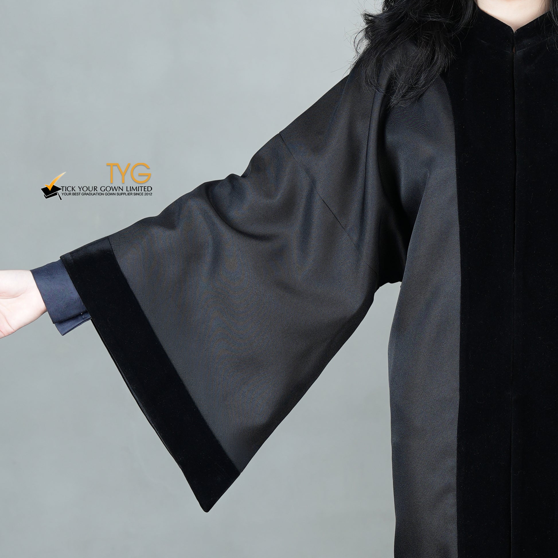 A detailed view of the sleeve of a bachelor black velvet traditional gown