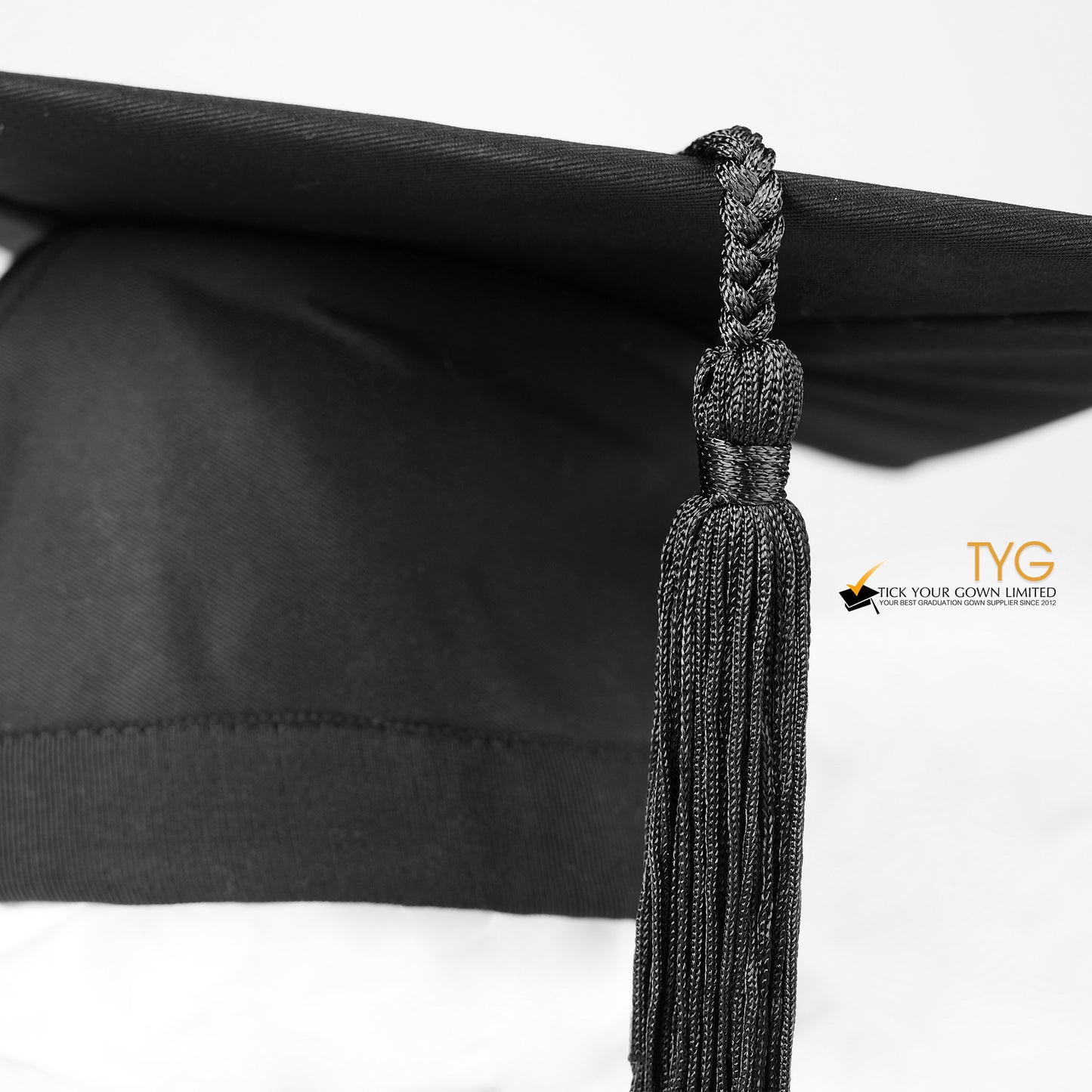 A detailed view of a black tassel on a white background.