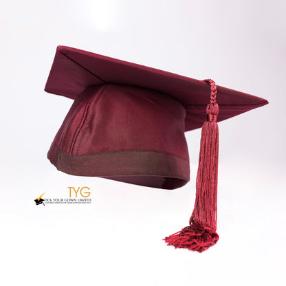 Red graduation cap with a red tassel on a white background.