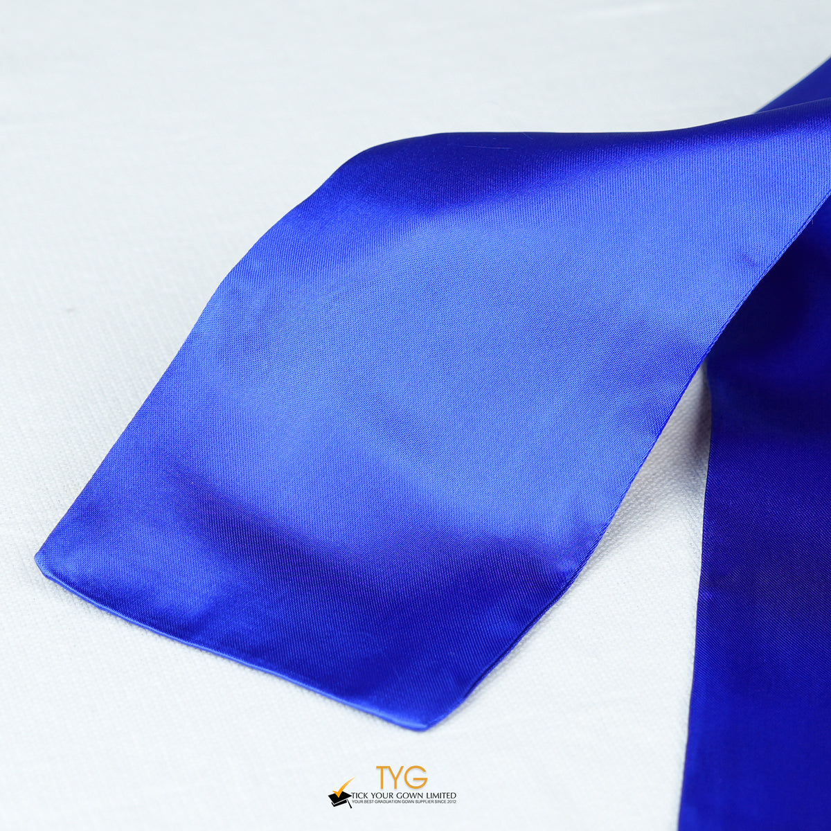 Detailed view of a navy blue graduation sash fabric on a white background.