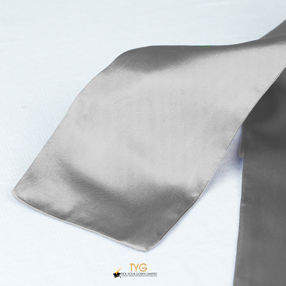 Detailed view of a silver graduation sash fabric on a white background.