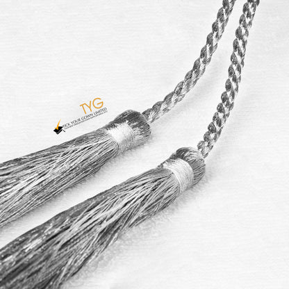 A detailed view of two braided silver tassels on a white background