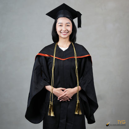 Graduate in black cap and gown with gold honour cords against a gray background