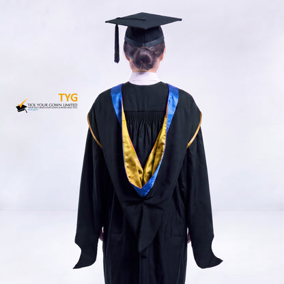 A back view of a woman in a black master's graduation gown classic UK with a blue hood with gold trim accent and with a black mortarboard cap with a black tassel against a gray background.