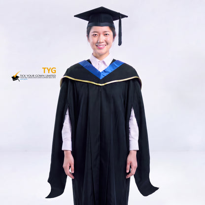 A woman in a black master's graduation gown classic UK with a blue hood with yellow trim accent and with a black mortarboard cap with an black tassel against a gray background.