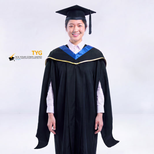 A woman in a black master's graduation gown classic UK with a blue hood with yellow trim accent and with a black mortarboard cap with an black tassel against a gray background.