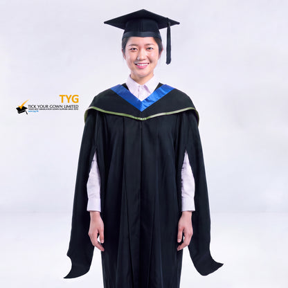 A woman in a black master's graduation gown classic UK with a blue hood with green accent and with a black mortarboard cap with an black tassel against a gray background.