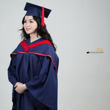 A profile view of a person in a navy blue graduation gown and a red hood and with a mortarboard cap with a red tassel against a gray background.