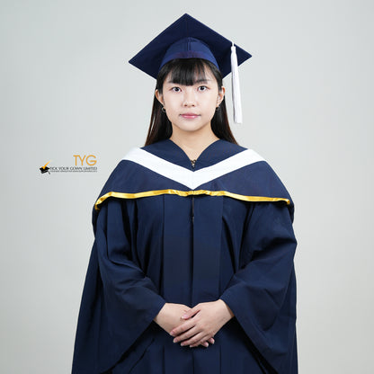 A person in a navy blue graduation gown and a white hood with gold lining and with a mortarboard cap with a white tassel against a gray background.
