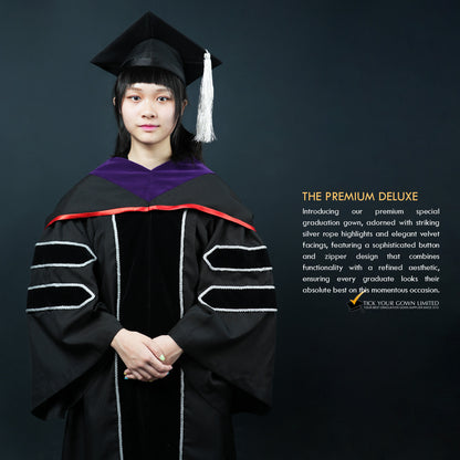 A person wearing a black velvet graduation gown with silver lining and a purple-and-red hood, a mortarboard witha silver tassel, standing in front of a dark background, with text describing the product as 'THE PREMIUM DELUXE'.