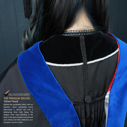 Close-up back view of a masters graduation gown showing the blue velvet hood with red trim and silver lining detail.