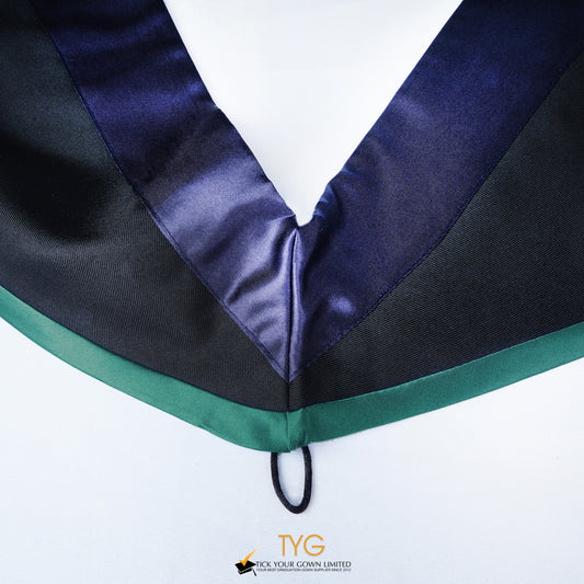Close-up of a master's graduation hood with black body, dark navy blue satin hood and emerald lining.