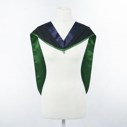 Master's graduation hood displayed on a mannequin showing full shape with black body, dark navy blue hood, and green satin lining.