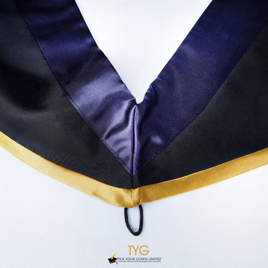 Close-up of a master's graduation hood with black body, dark navy blue satin hood and gold lining.