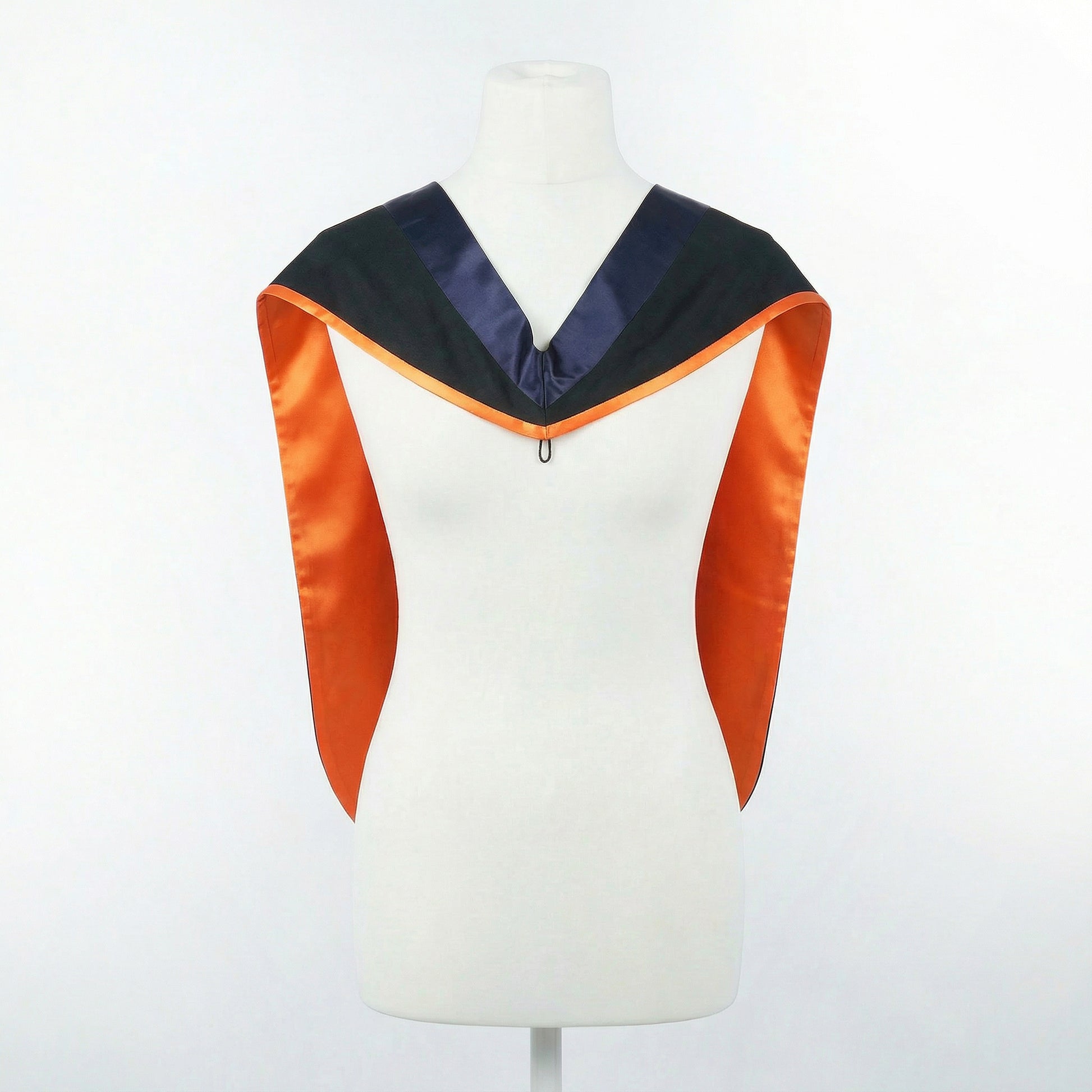 Master's graduation hood displayed on a mannequin showing full shape with black body, dark navy blue hood, and orange satin lining.