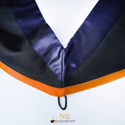 Close-up of a master's graduation hood with black body, dark navy blue satin hood and orange lining.