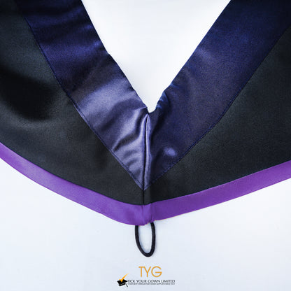 Close-up of a master's graduation hood with black body, dark navy blue satin hood and purple lining.