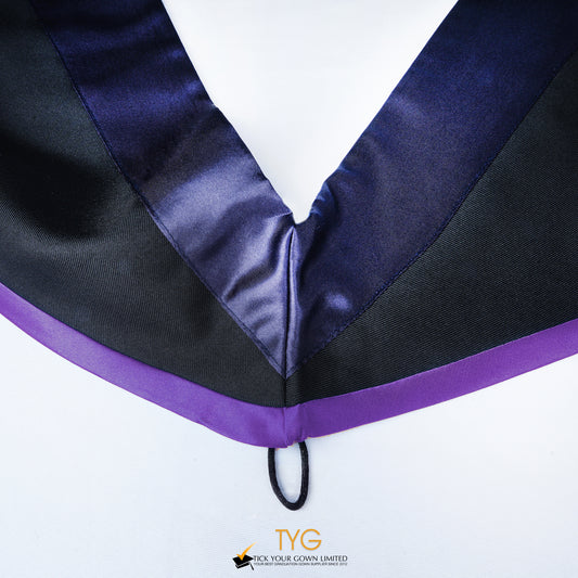 Close-up of a master's graduation hood with black body, dark navy blue satin hood and purple lining.