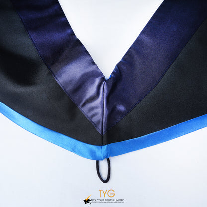 Close-up of a master's graduation hood with black body, dark navy blue satin hood and skyblue lining.