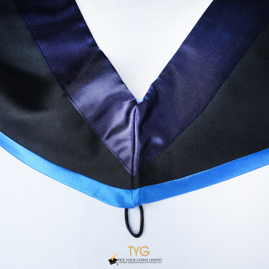 Close-up of a master's graduation hood with black body, dark navy blue satin hood and skyblue lining.