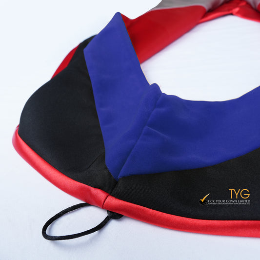Close-up of a master's graduation hood featuring black fabric with blue velvet hood and red satin lining.