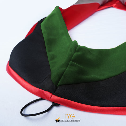 Close-up of a master's graduation hood featuring black fabric with forest green velvet hood and red satin lining.