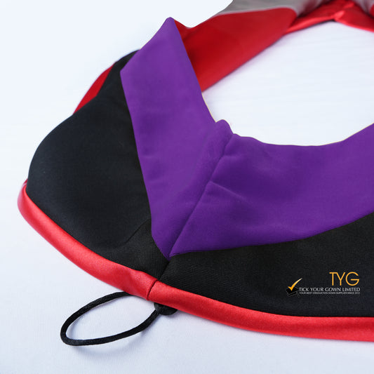 Close-up of a master's graduation hood featuring black fabric with purple velvet hood and red satin lining