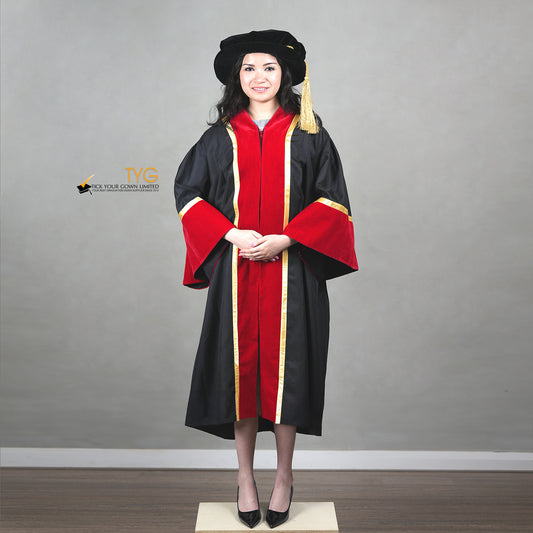 Front view of a person wearing a black and red graduation gown accented with gold lining with a hood on a gray background
