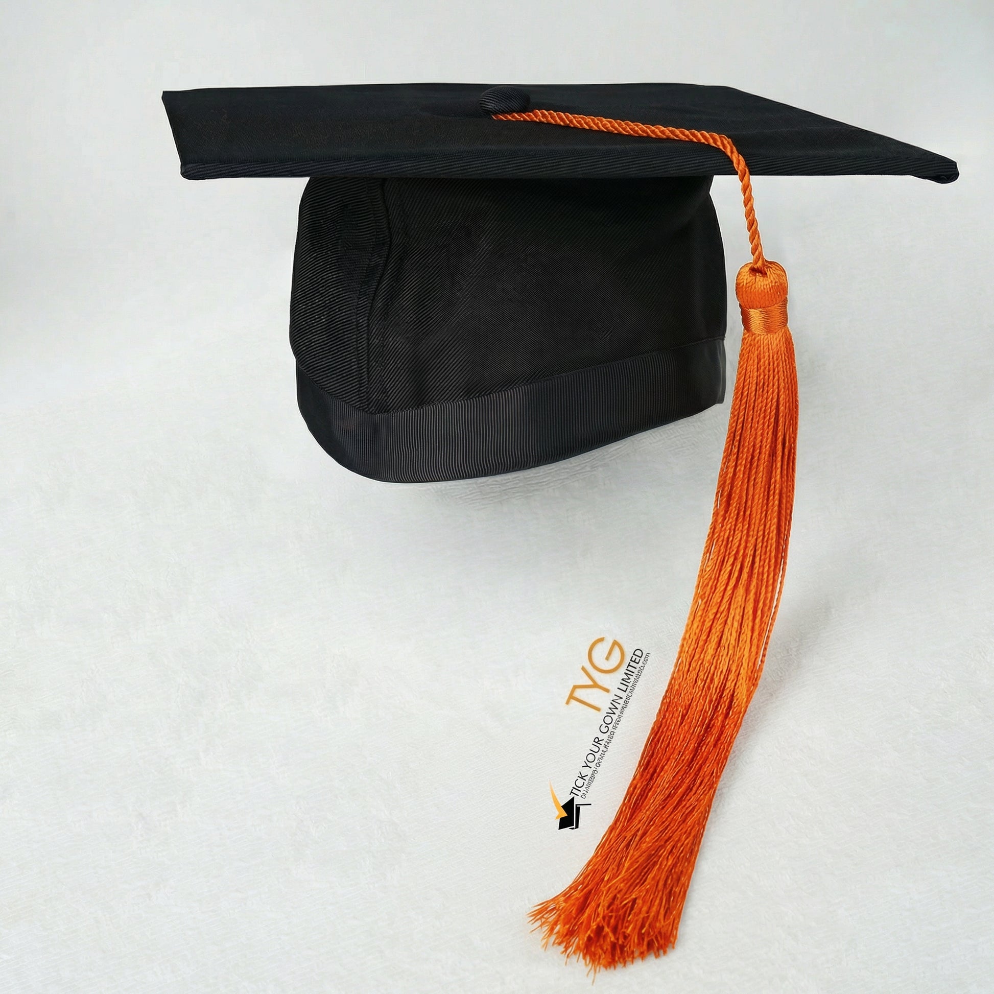 Black graduation cap with orange tassel on a white background