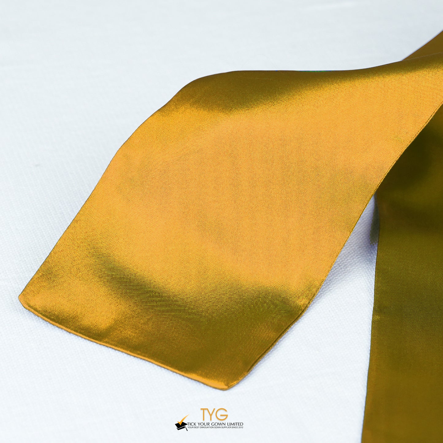 Detailed view of a orange graduation sash stole fabric on a white background.