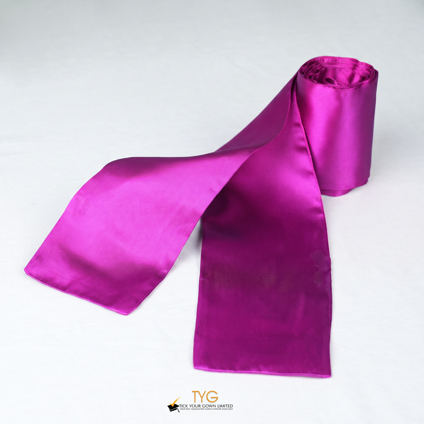 Pink satin rolled graduation sash stole on a white background.