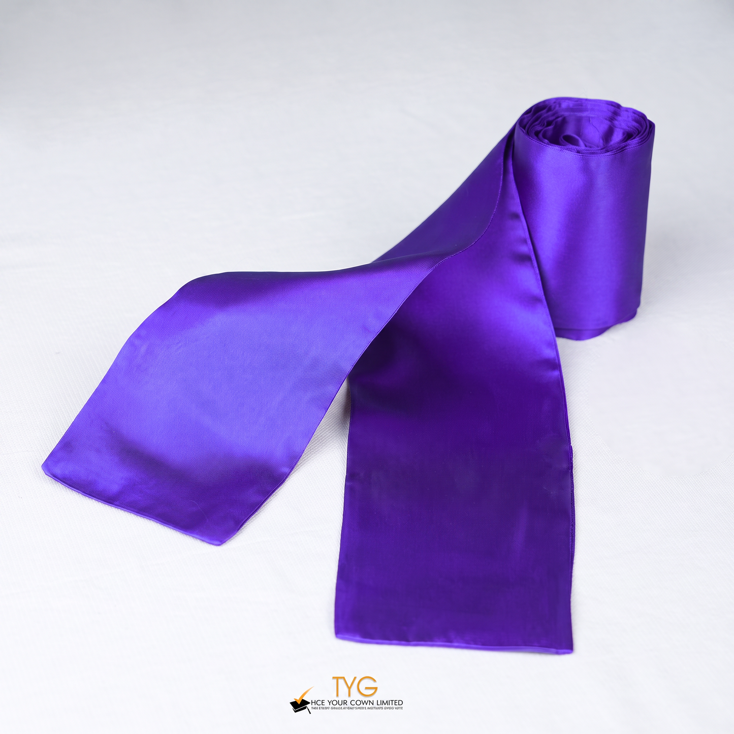 Purple satin rolled graduation sash stole on a white background.